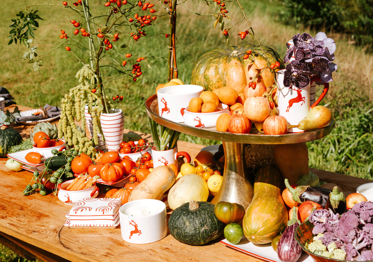 Gmundner ceramics on an autumn table with pumpkins and seasonal foliage
